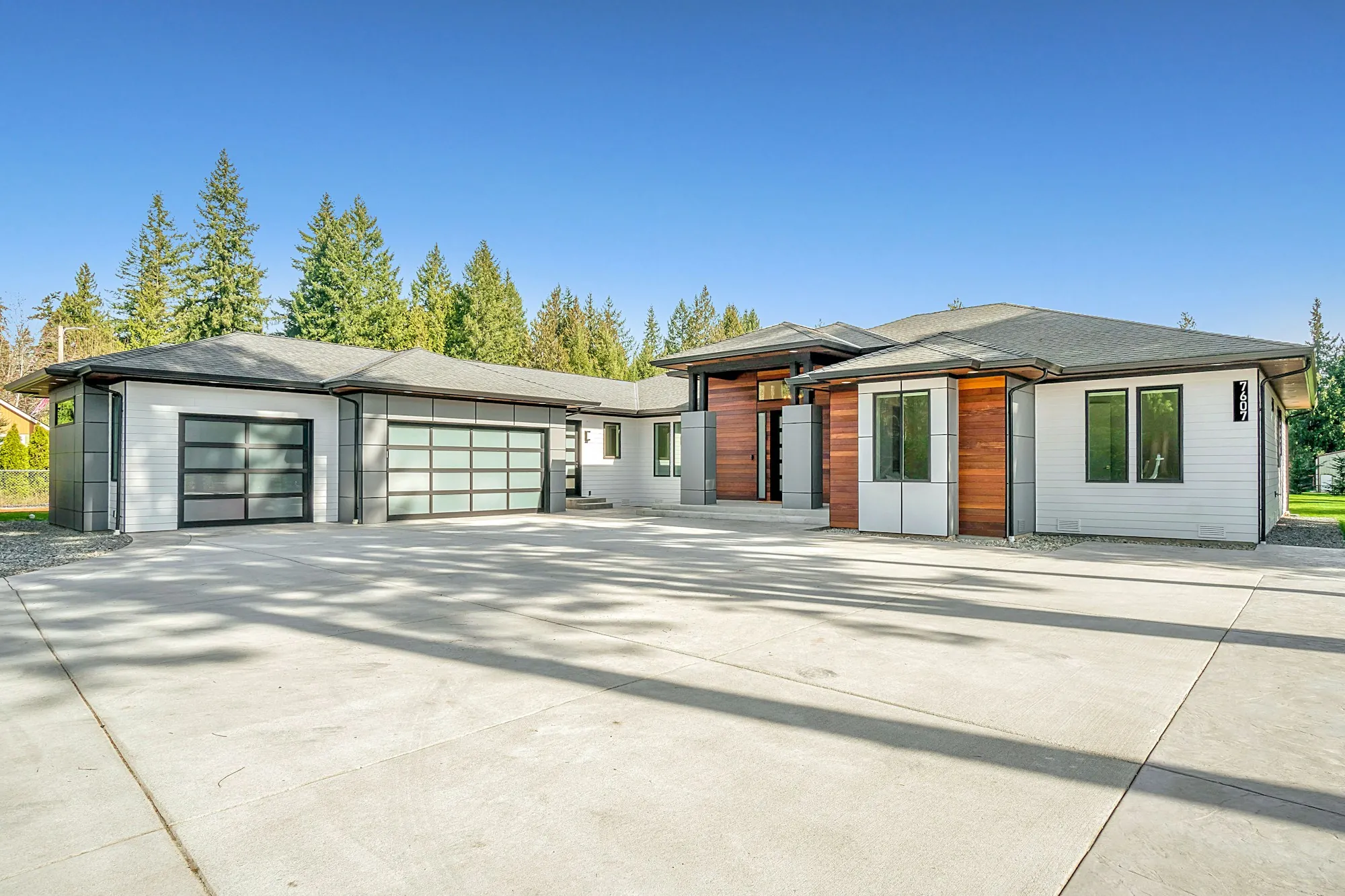 Modern single-story homes with glass garage doors