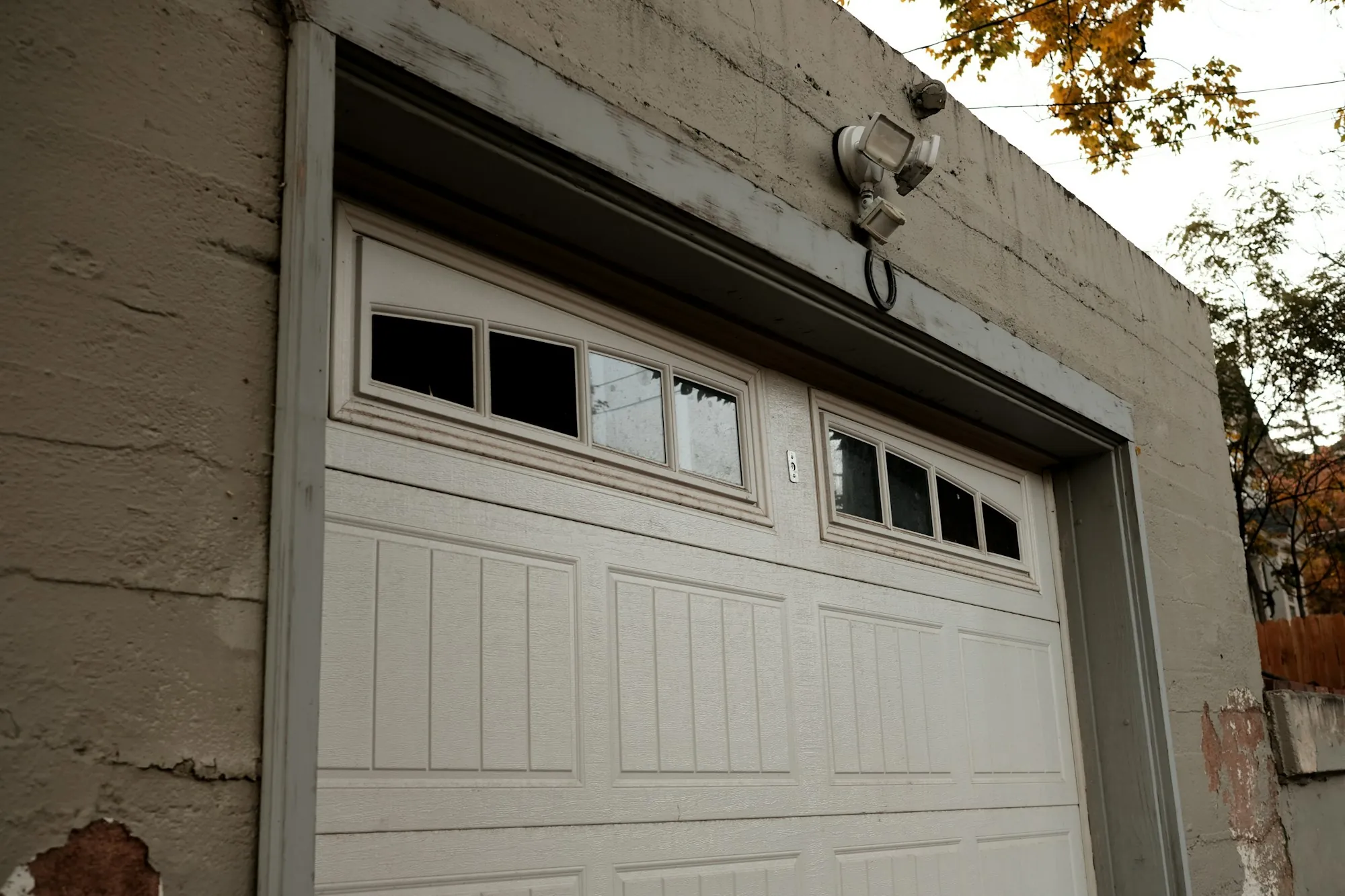 White carriage-style garage door with a row of windows